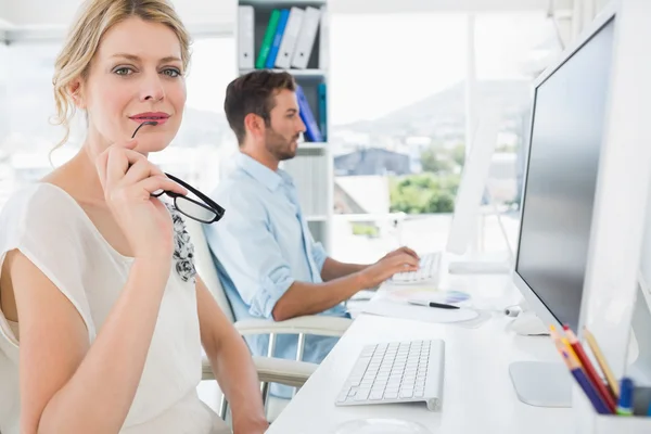 Sorridente casuale giovane coppia di lavoro su computer — Foto Stock