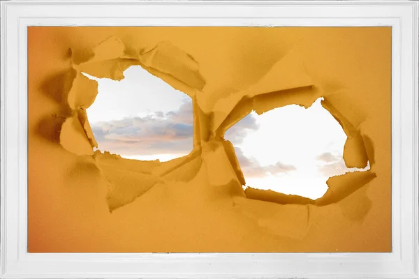 Rip on wall showing bright sky — Stock Photo, Image