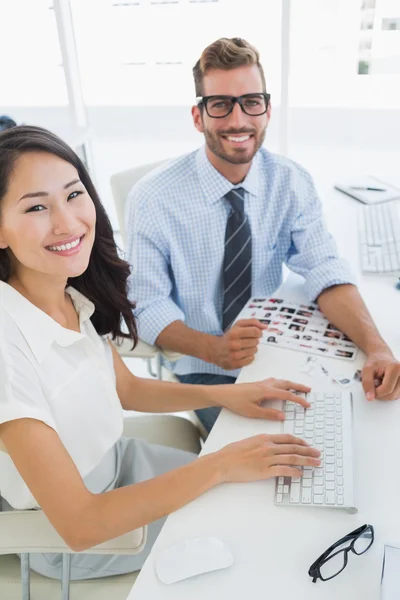 Side view of casual photo editors working on computer — Stock Photo, Image