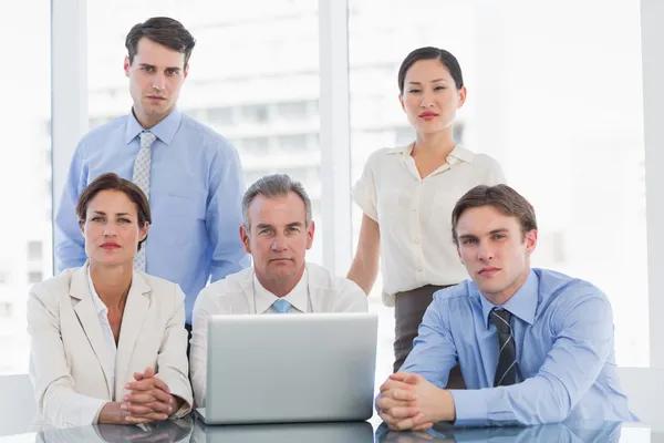 Business colleagues with laptop at desk — Stock Photo, Image