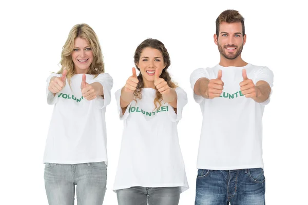 Retrato de três voluntários felizes gestando polegares para cima — Fotografia de Stock