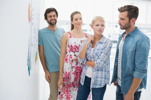 Artists in discussion in front of whiteboard — Stock Photo, Image
