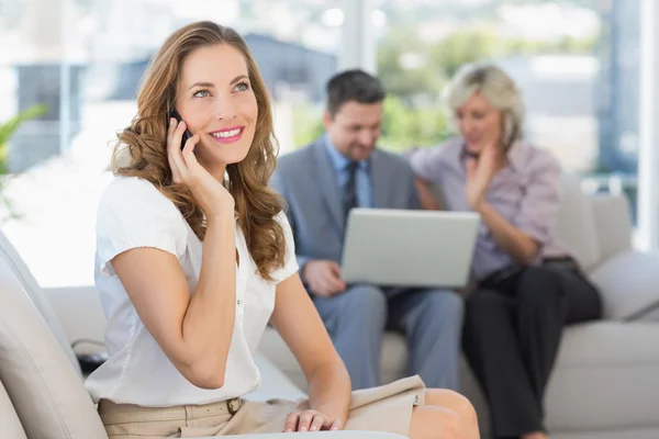 Empresaria de guardia con colegas usando laptop — Foto de Stock