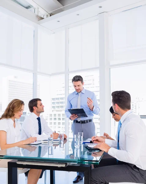 Leidinggevenden zitten rond de conferentietafel — Stockfoto