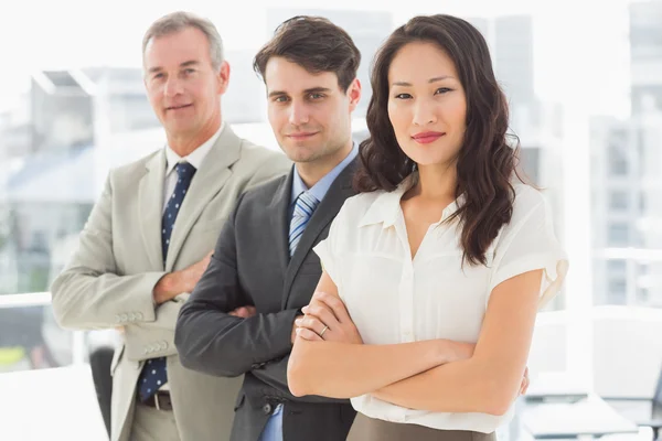 Business team standing in a row smiling at camera — Stock Photo, Image