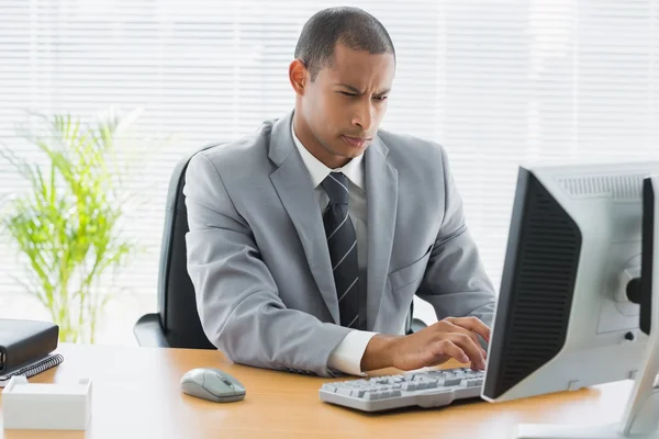 Concentrated businessman using computer at office — Stock Photo, Image
