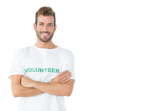 Portrait of a happy male volunteer standing with hands crossed — Stock Photo, Image