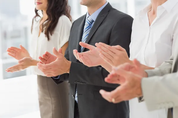 Business team stående i en rad applåderar — Stockfoto
