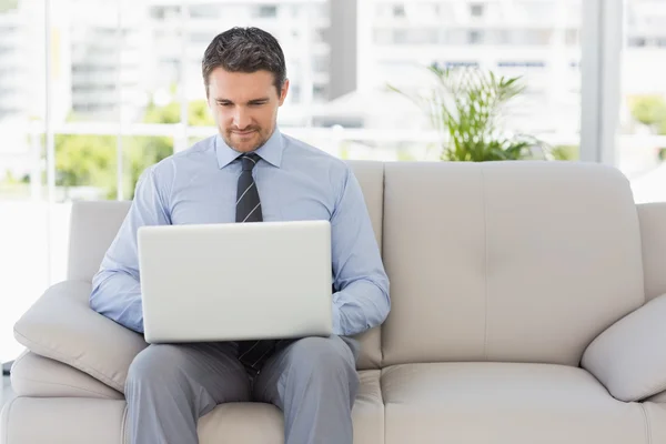 Well dressed man using laptop at home — Stock Photo, Image