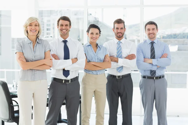 Confident business team with arms crossed in office — Stock Photo, Image