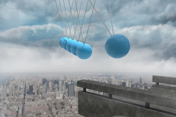 Newtons cradle above city — Stock Photo, Image