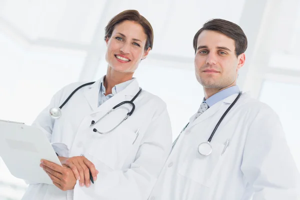 Doctors with report in hospital — Stock Photo, Image
