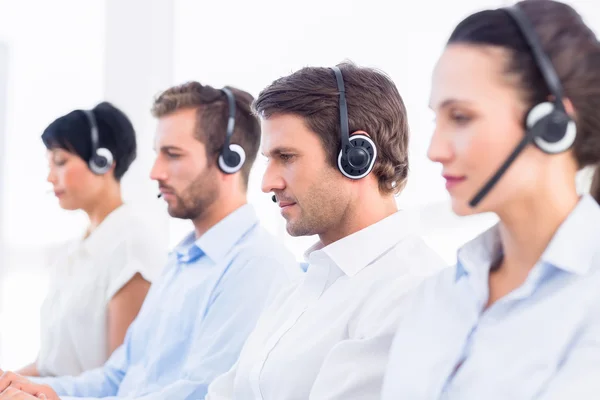Groep van collega's met headsets in een rij — Stockfoto