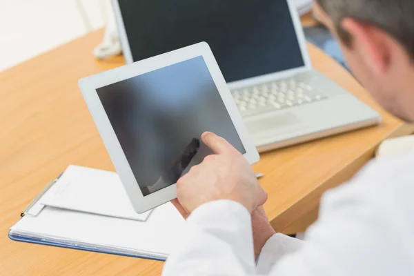 Doctors using laptop and digital tablet in meeting — Stock Photo, Image