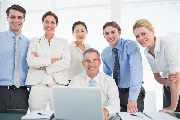 Business colleagues with laptop at desk — Stock Photo, Image