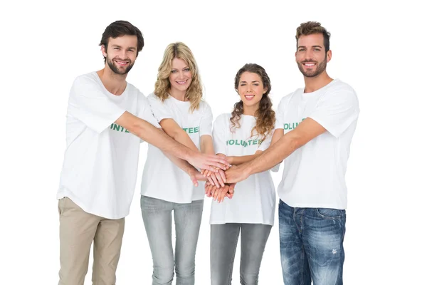 Portret van gelukkig vrijwilligers met handen groeperen — Stockfoto