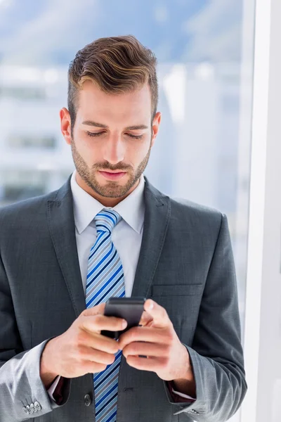 Handsome young businessman text messaging — Stock Photo, Image