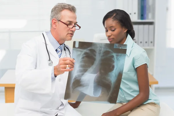 Doctor showing young patient her chest xray — Stock Photo, Image