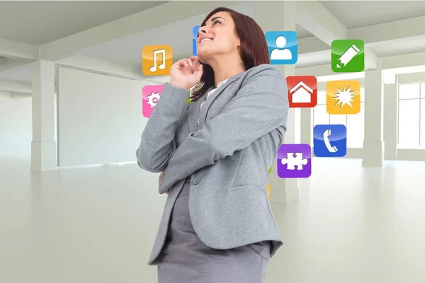 Composite image of smiling thoughtful businesswoman — Stock Photo, Image