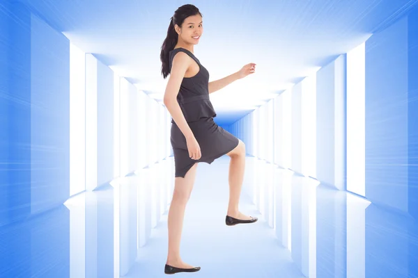 Composite image of businesswoman stepping up — Stock Photo, Image