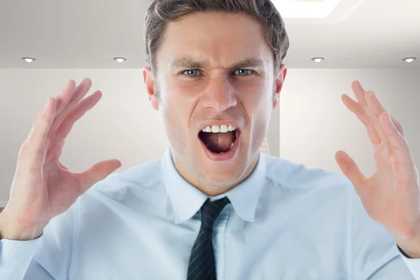 Composite image of angry businessman shouting — Stock Photo, Image