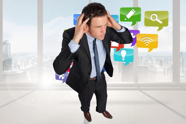 Composite image of stressed businessman with hands on head — Stock Photo, Image