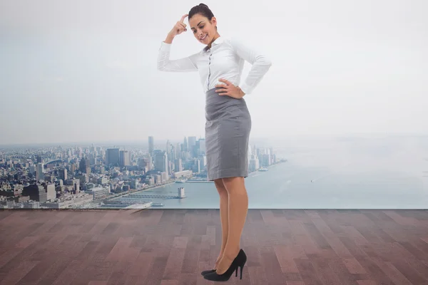Composite image of smiling thoughtful businesswoman — Stock Photo, Image