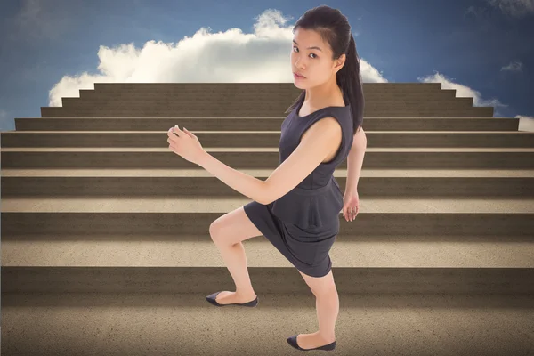 Composite image of businesswoman stepping up — Stock Photo, Image