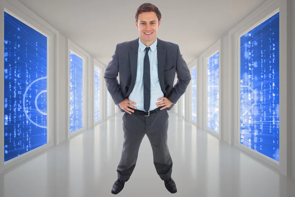 Composite image of cheerful businessman standing with hands on h — Stock Photo, Image