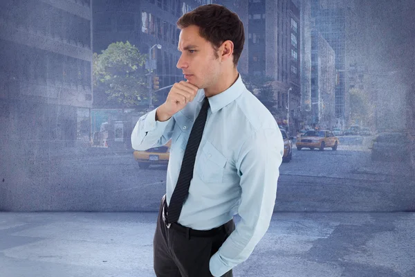 Composite image of thoughtful businessman with hand on chin — Stock Photo, Image