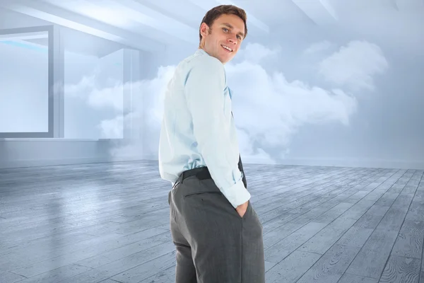 Image composite d'un homme d'affaires heureux debout avec les mains dans la poche — Photo