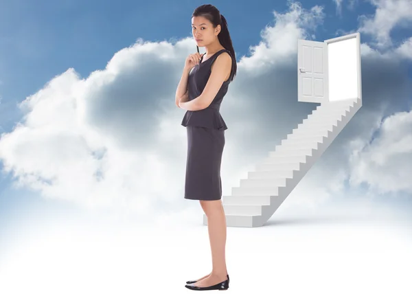 Composite image of thoughtful businesswoman — Stock Photo, Image