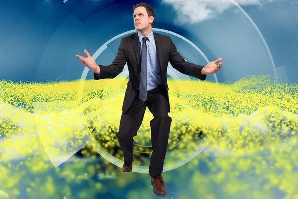 Composite image of businessman posing with arms outstretched — Stock Photo, Image