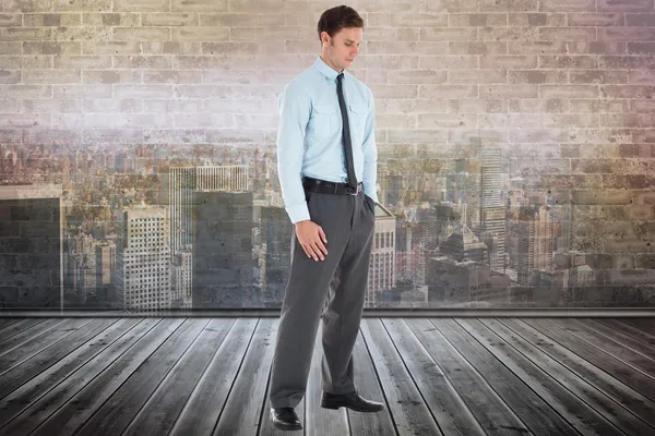 Composite image of serious businessman standing with hand in poc — Stock Photo, Image