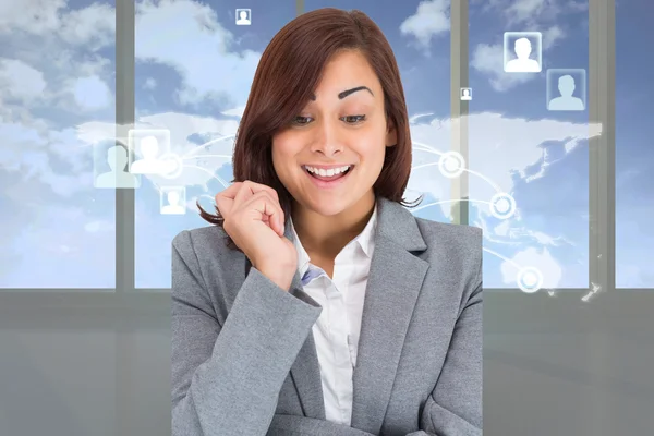 Composite image of smiling thoughtful businesswoman — Stock Photo, Image