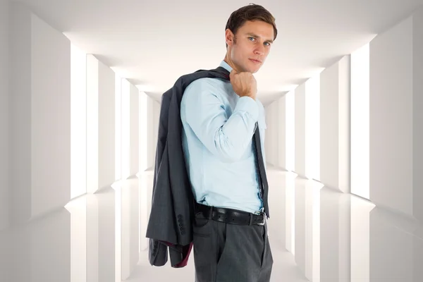 Imagen compuesta de un hombre de negocios serio sosteniendo su chaqueta —  Fotos de Stock