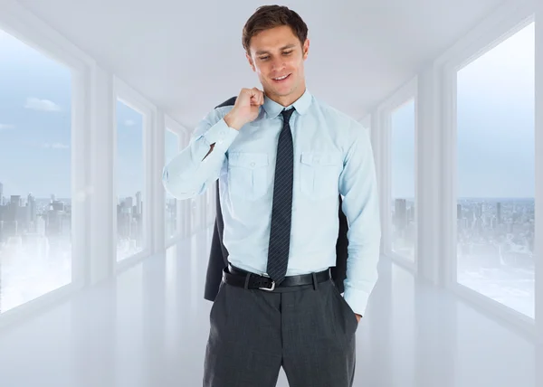 Composite image of smiling businessman holding his jacket — Stock Photo, Image