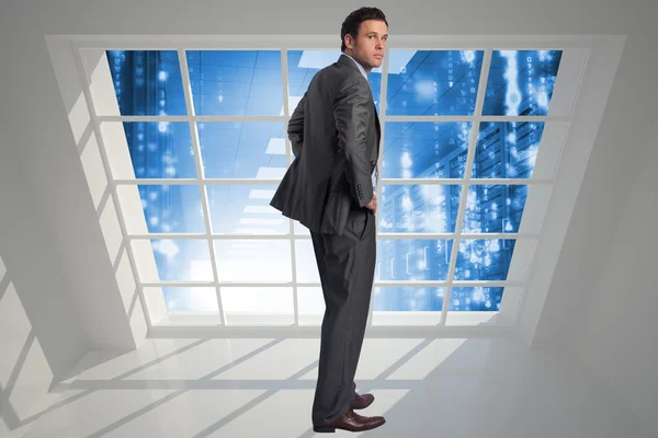 Composite image of businessman with hands on hips — Stock Photo, Image