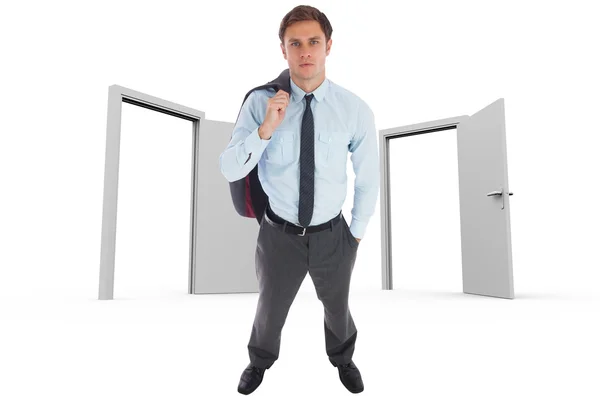 Composite image of serious businessman holding his jacket — Stock Photo, Image