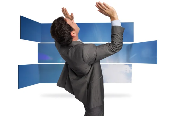 Composite image of businessman standing with arms pressing up — Stock Photo, Image