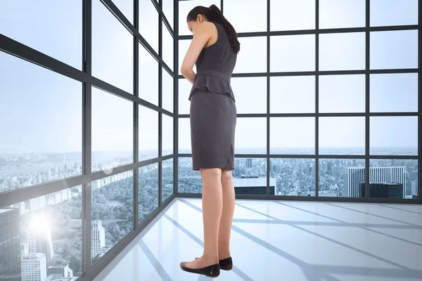 Composite image of thinking asian businesswoman — Stock Photo, Image