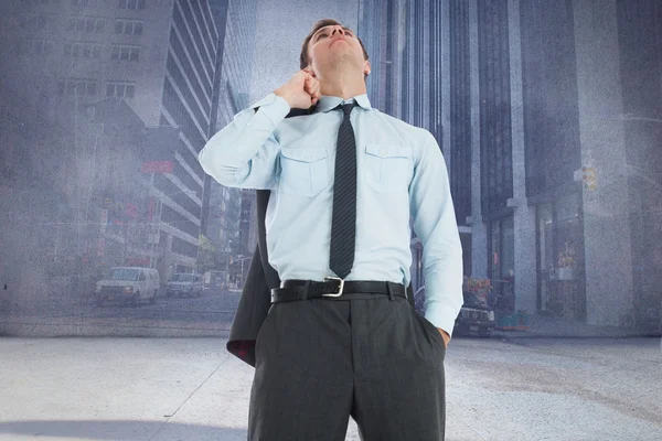 Composite image of serious businessman holding his jacket — Stock Photo, Image