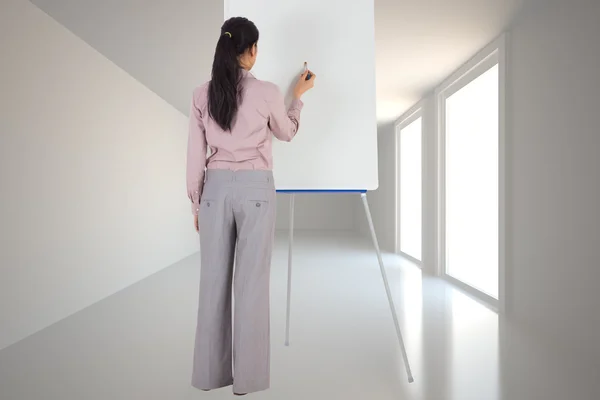 Composite image of businesswoman painting on an easel — Stock Photo, Image