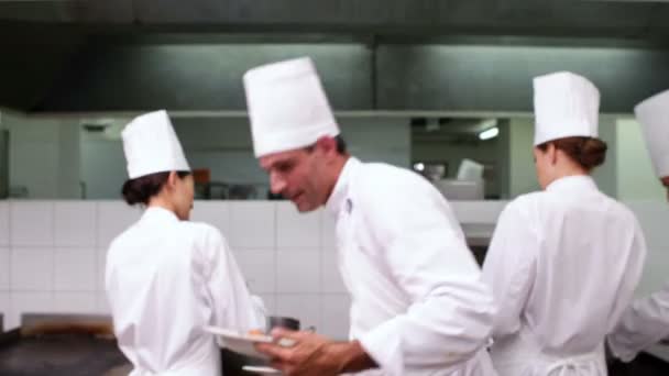 Happy chef showing two dishes to camera — Stock Video