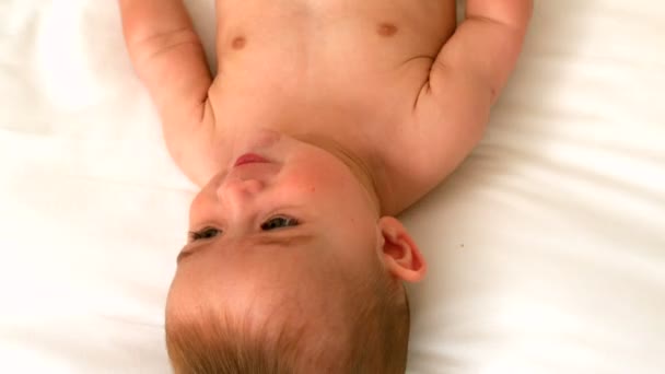 Schattige baby op een bed — Stockvideo