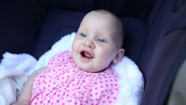 Baby girl sitting in her pram — Stock Video