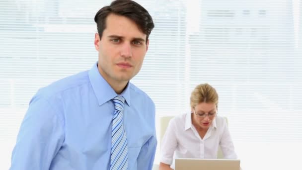 Businessman with colleague behind him — Stock Video