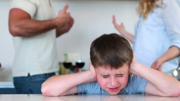 Boy blocking out noise from parents fighting — Stock Video