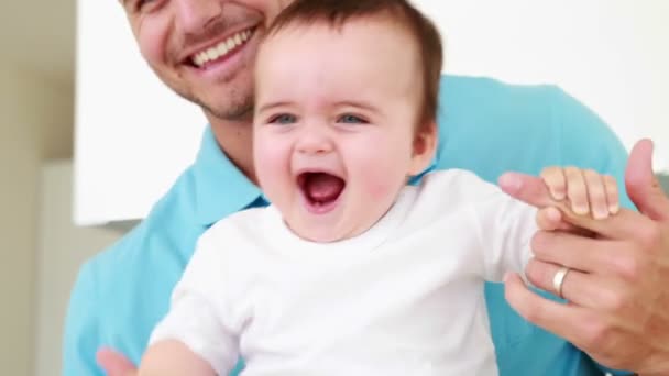 Father helping his baby boy stand up — Stock Video