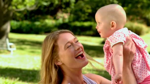 Mother lifting her baby girl in the air — Stock Video